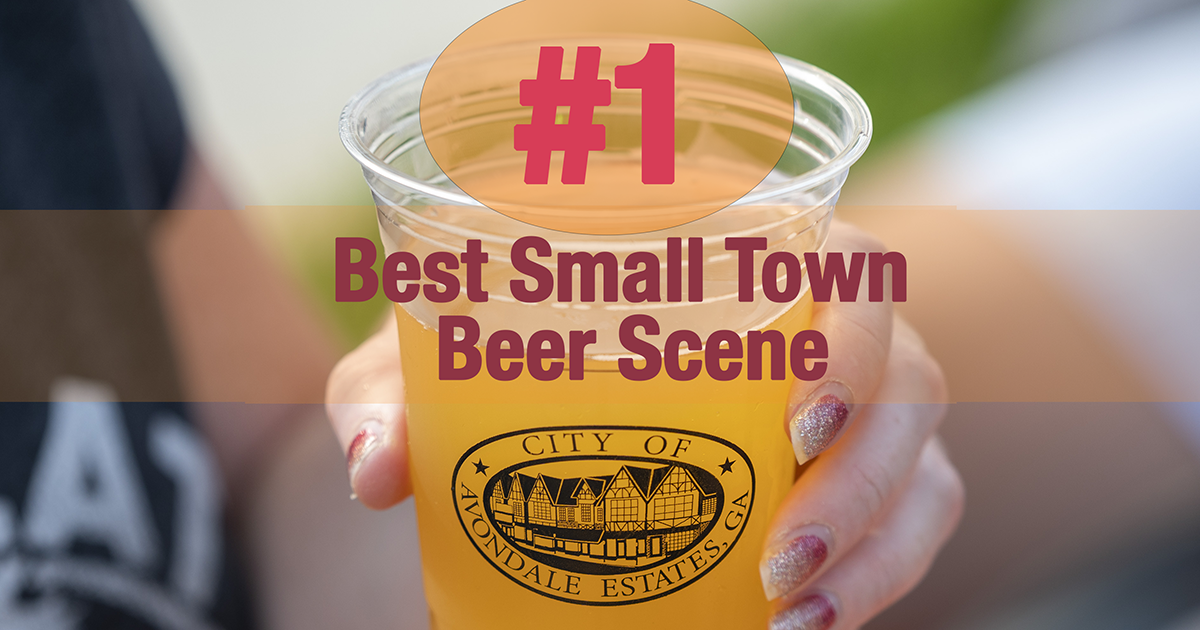 #1 Best Small Town Beer Scene with hand holding a beer in a to-go cup with the Avondale Estates' city logo